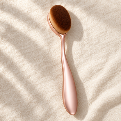 Oval Foundation Brush — overhead view on ivory linen